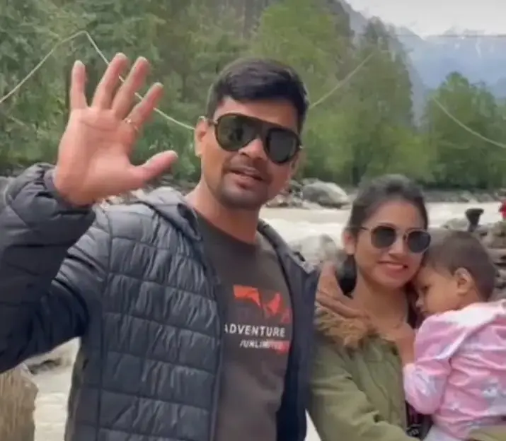 Holiday Globe guests with their child beside a mountain river