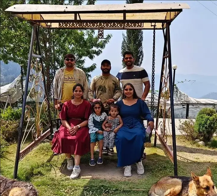 A group of Holiday Globe guests posing together on a garden swing